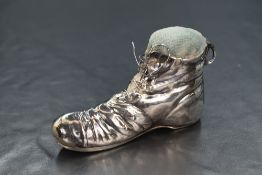 An early George V silver novelty pin cushion, in the form of a boot, having a pale blue cushion to