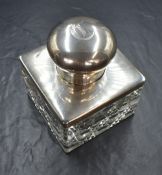A large George V silver mounted cut glass inkwell, of square form having a decorative cut glass