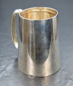 A George V silver tankard, of slightly fluted form having a c-curve handle and personalised