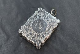 A late Victorian silver vinaigrette, of hinged rectangular form having an overhanging scallop-edged,