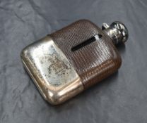 A George VI silver mounted glass hip flask, of traditional form having a silver mount and cap to the