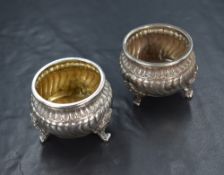 A pair of Victorian imported Hanau silver salts, of circular form having embossed decoration to