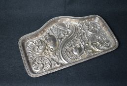 An Edwardian silver vanity tray, of rectangular form having a gadrooned rim with embossed scroll and