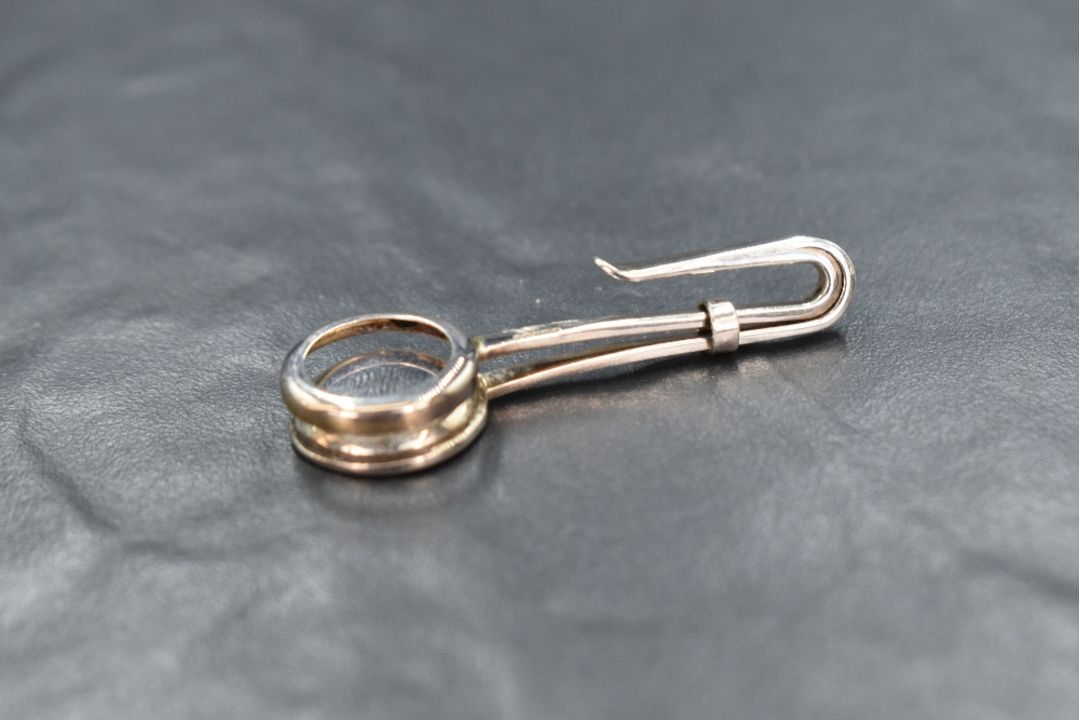 An Elizabeth II silver skirt lifter having a circular openwork design, marks for Sheffield 2006, - Image 2 of 2