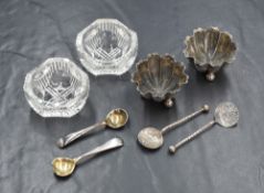A cased pair of Victorian silver salts, of circular lobed flower design, raised on three ball