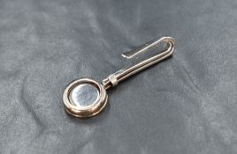 An Elizabeth II silver skirt lifter having a circular openwork design, marks for Sheffield 2006,