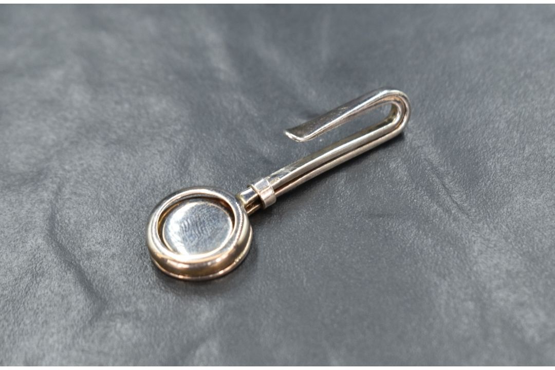 An Elizabeth II silver skirt lifter having a circular openwork design, marks for Sheffield 2006, - Image 1 of 2