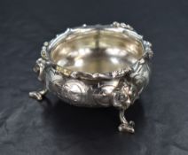 A Victorian silver salt, of bulbous circular form having an overhanging scroll rim with decorative