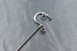 A Charles Horner silver hat pin, of scrolling 'C' form, 19.5cm, marks for Chester 1913, 3.2g
