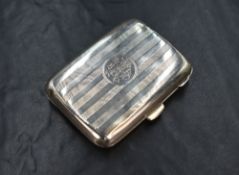 A George V silver cigarette case of hinged rectangular form slightly curved for the gentleman's