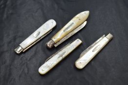 A group of four silver bladed fruit knives, of various size and design, all having mother-of-pearl