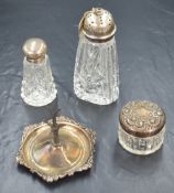 A George V silver jewellery and ring stand, having an embossed scroll rim and tree like stand to the