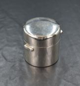 An Edwardian silver travel inkwell, of plain circular form, having a hinged lid and a further