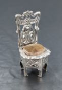 An Edwardian silver novelty pin cushion, in the form of an Art Nouveau style chair, having a worn