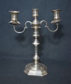 An Elizabeth II silver two-branch candlestick, of turned and octagonal form, the central columns top