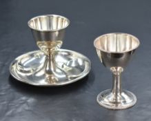 A George III silver pedestal egg cup, of traditional form having a bead thread rim and heraldic