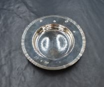 An Elizabeth II silver armada dish, of traditional form having line decoration and personal