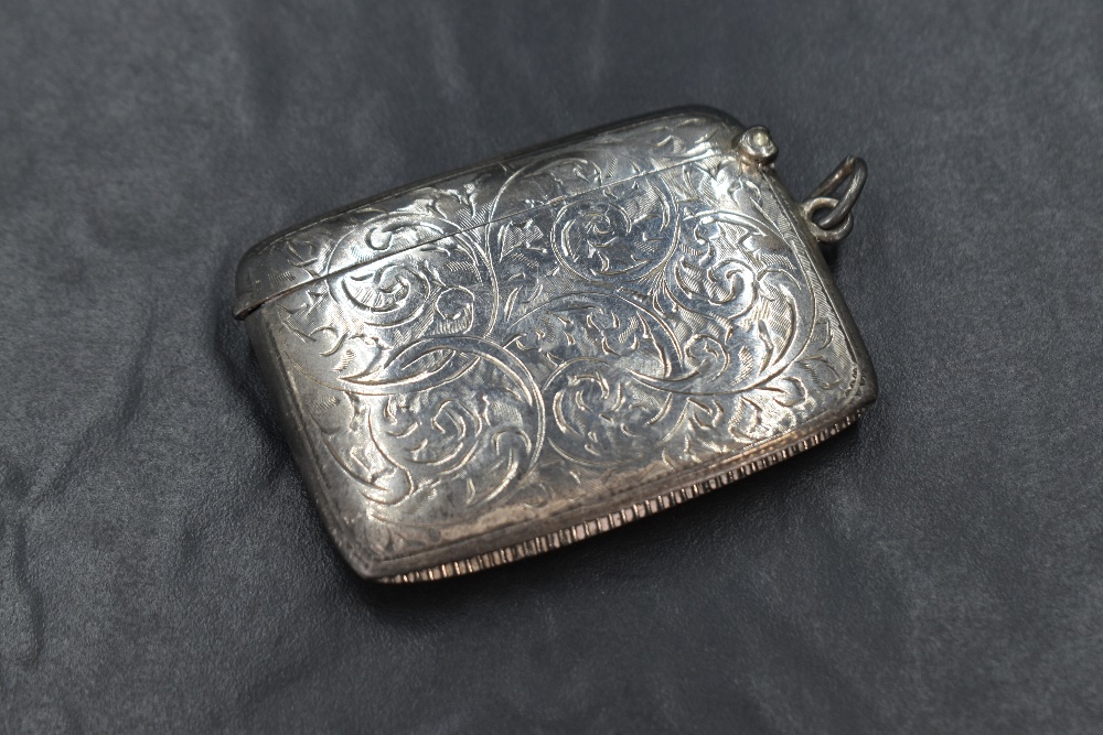 A George V silver vesta case, of rectangular form having engraved scroll decoration and central - Image 2 of 2