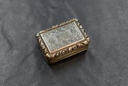 A George IV silver gilt vinaigrette, of hinged rectangular form, having a raised floral scroll