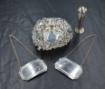 An Edwardian silver trinket dish, having pierced embossed decoration, raised on three ball feet,