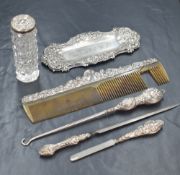 A late Victorian silver pin tray, of oblong form having embossed scroll decoration to the rim, marks