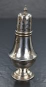 A George VI silver sugar caster, having a pierced, finial topped cover over the fluted baluster