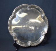 A late Edwardian silver salver, having a lobed rim with gadrooned sections and shell decoration,
