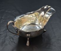 An Elizabeth II silver sauce boat, having a Chippendale style rim and generous spout opposed by a