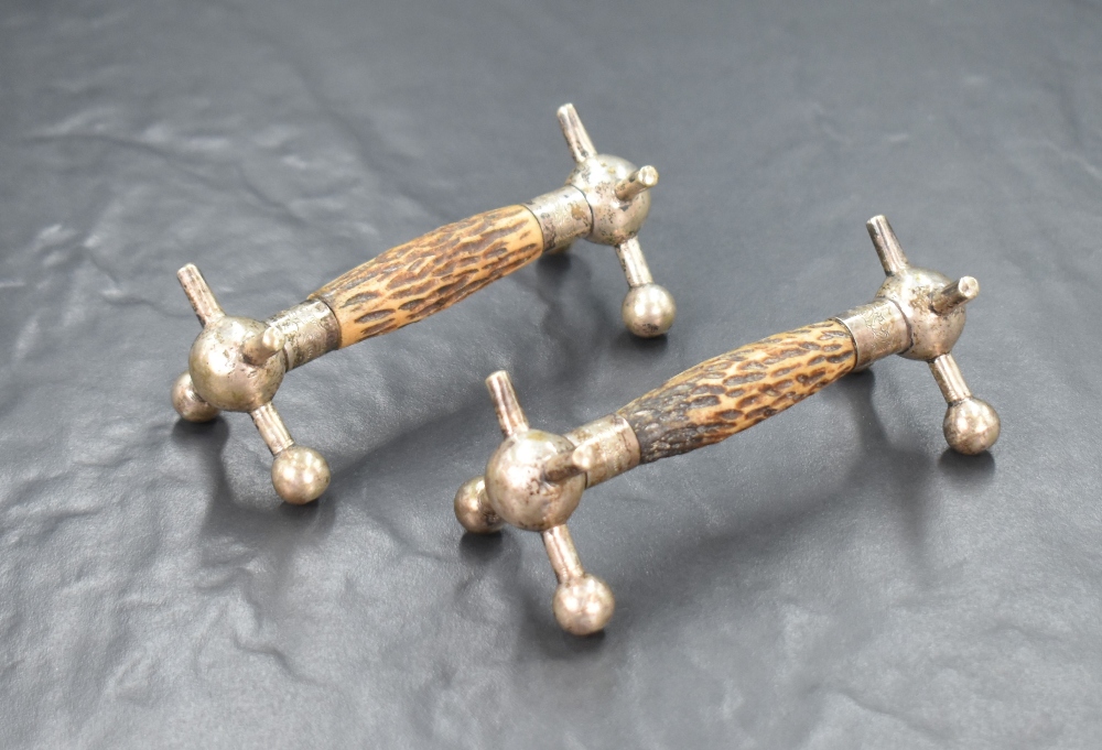 A pair of white metal and antler knife rests, of traditional form having central antler bars, raised - Image 2 of 2