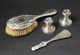 A George V silver mounted hairbrush, having engine turned and embossed decoration, along with two
