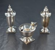 An Elizabeth II silver three piece condiment set, comprising salt, mustard and pepper, of plain