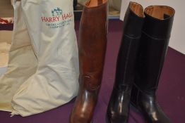 2 sets of riding boots one simulated leather and a set of brown leather boots in a harry hall boot