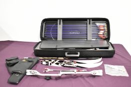 A Cartel archery set in hard zipped case with 8 Eastern arrows and accessories including string and