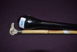An ebonised police or knocking stick 91cm long and a small cane stick 77cm long with carved horn