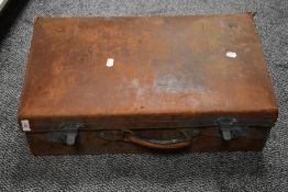A early 20th century brown leather suitcase, w60cm. A/F.
