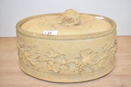 A 19th Century Wedgwood buff stoneware game pie dish and cover, decorated in relief with fruiting