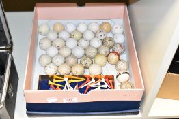 A box containing golf balls and golf ball tee's, (39).