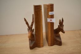 A pair of wooden bookends modelled with sitting Gazelles, factory stamp to base 'hand carved in