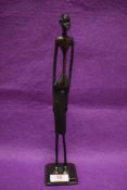 Local interest; A contemporary bronze effect elongated figure of an African tribesman, h31cm.