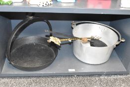 A 19th Century cast iron skillet pan, the base unmarked with a diameter of 32cm, a stainless steel