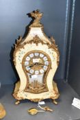 A reproduction French style mantel clock by Franz Hermle, the shaped case decorated with a printed
