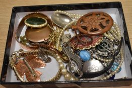 An assortment of costume jewellery, including faux pearls, enamel pieces, brooches, and paste set