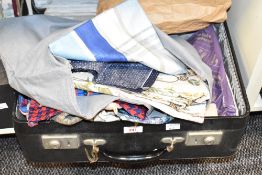 A vintage faux leather suitcase containing various fabric, mainly off cuts, to include cotton,