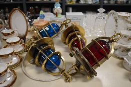 A group of early / mid 20th century brass ship lamps having ruby and turquoise colour globes,