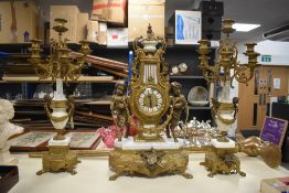An early 20th century continental cast brass and white marble garniture set. Standing on lion's
