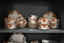 An early 20th century Melba part dinner service, decorated in the Imari pattern, to include cups,