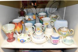 A large selection of vintage tea pots and jugs, having multicoloured foliage, to include Crown Ducal