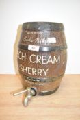 A vintage ceramic sherry barrel with tap, moulded as a coopered wooden barrel, scripted label