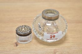 An early 20th century controlled bubble clear glass inkwell, h5.5cm, sold together with a small