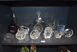 A group of clear and frosted glass paperweights depicting wild birds, some etched underneath '